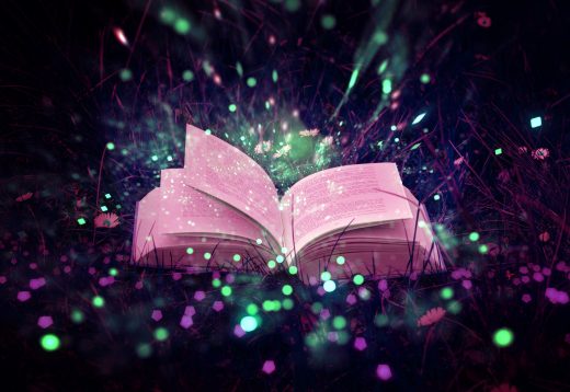 An open book with magic sparkles coming out of the pages.